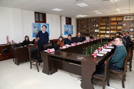 A group of people sitting at a table in a room

Description generated with very high confidence